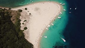 Aerial drone video from famous for Caretta caretta sea turtle haching, exotic small island of Marathonisi with white caves and sapphire sea and sandy beach , Zakynthos island, Ionian, Greece