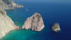 Aerial drone view video of rocky steep cliff white seascape with beautiful turquoise sea and two small islets called Mizithres in West side of Zakynthos island, Ionian islands, Greece
