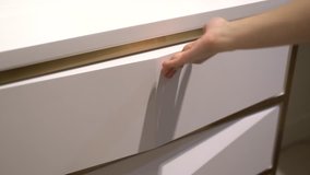 clip of Use hand pull open and push close drawer wooden in cabinet.