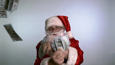 Santa Claus dancing on a white background with money in his hands.