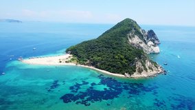 Aerial drone view video of iconic small uninhabited island of Marathonisi featuring clear water sandy shore and natural hatchery of Caretta-Caretta sea turtles, Zakynthos island, Ionian, Greece