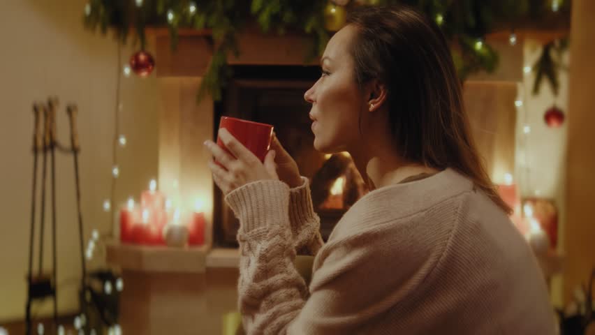 Woman with a cup of hot drink at Christmas time | Shutterstock HD Video #1017125269