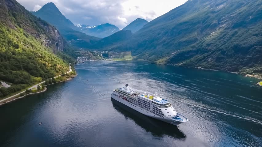 Cruise Ship, Cruise Liners On Geiranger fjord, Norway. It is a 15-kilometre (9.3 mi) long branch off of the Sunnylvsfjorden, which is a branch off of the Storfjorden (Great Fjord). Royalty-Free Stock Footage #1017125524