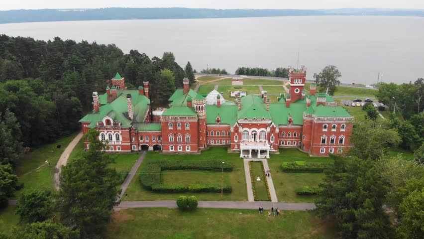 Sheremetev castle palace and park ensemble in the village of Yurino on the bank of the Volga, combination of different architectural styles in one building. Cloudy weather at the beginning of summer.
