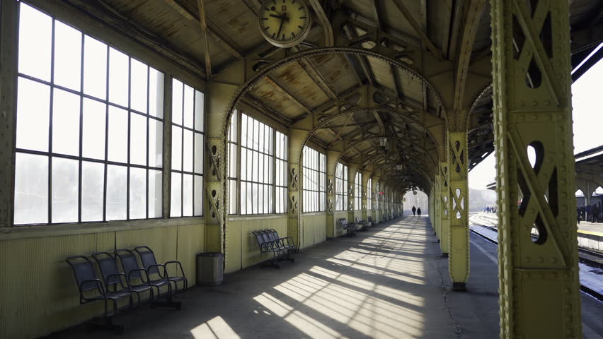 Point of view walking on the railway platform in art nouveau style. Deserted plarform at early morning, sun shine through big window. Vitebskiy Railway Station in St. Petersburg, Russian Federation.