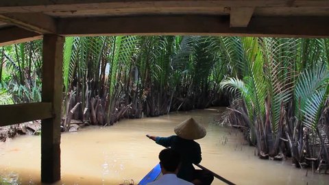Stunning View of a Local Boat Paddling in the Mekong Delta (Vietnam)