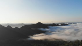 Landscape of Morning Mist with Mountain Layer at  north of Thailand. Aerial View. Flying over the high mountains in beautiful clouds . Aerial video shot.