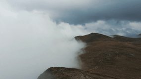 Footage of dramatic clouds high in Carpathian mountains.Heavy fog on hills in Carpathians in cold autumn day with bad weather.Travel destination for hikers and active tourism in Southern Europe