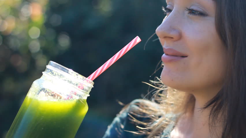 Woman is drinking green smoothies close-up. Concept of detox, diet, vegetarianism, healthy lifestyle. Royalty-Free Stock Footage #1017166273