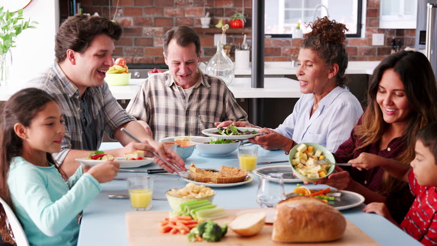 Multi Generation Family Enjoying Meal Around Table At Home | Shutterstock HD Video #1017166954