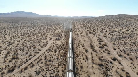 Aerial Drone Views Flying Over Train Going Through Mojave Desert Dry Lands 