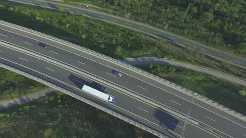 AERIAL: Freight truck driving over the viaduct highway