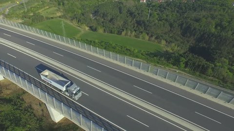 AERIAL: Cargo truck with empty container driving on the highway