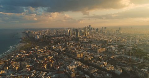 Tel Aviv Skyline from Drone. Aerial shot long super wide horizon view. Sunset orange Sky coastline and office building in a modern Tel Aviv 