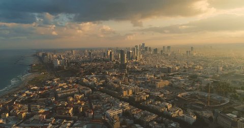 Tel Aviv Skyline from Drone. Aerial shot long super wide horizon view. Sunset orange Sky coastline and office building in a modern Tel Aviv 