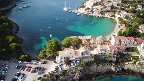 Aerial drone bird's eye view video of beautiful and picturesque colourful traditional fishing village of Assos in island of Cefalonia, Ionian, Greece