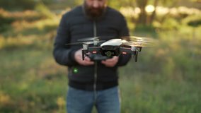 drone hanging in air in front of man with remote control