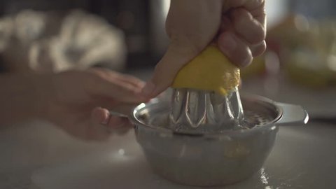 Close up of hands squeezing lemon juice