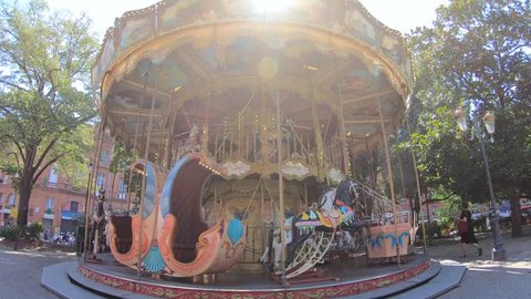 Classical French Carousel In Park, Jardin Pierre Goudouli, Spinning Around on A Bright Sunny Day, Toulouse, France