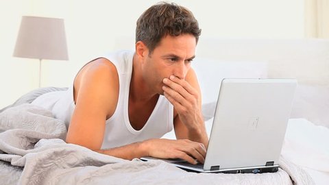 Annoyed man working on his laptop
