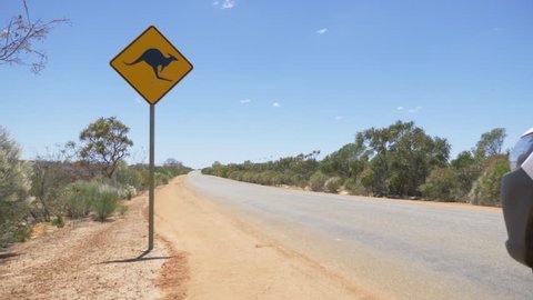 4K Camping Australia sign on road in desert