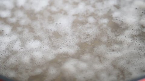 White foam from cannellini beans when boiling. Closeup