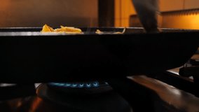 Frying potato with mushroom and onion on frying pan