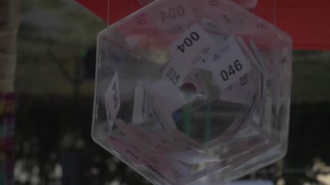 
Lottery tickets revolve in the lottery drum during the day. slow motion