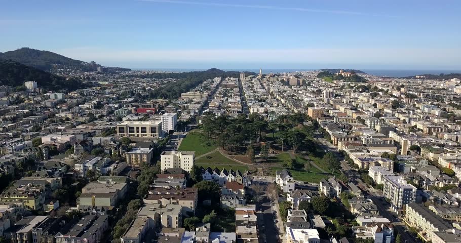 Beautiful cityscape with a green park on the background of the blue sky and the bay in San Francisco in California, USA. Sun is shining. Aerial video recording. Editorial.