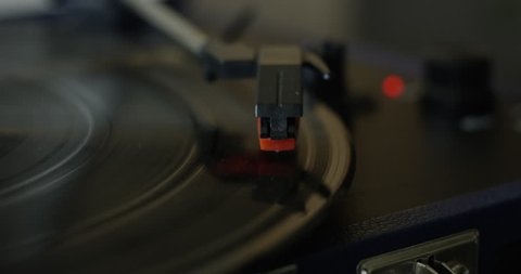Needle playing vinyl record on turn table extreme close up - slow motion