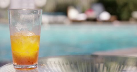 Tropical drink on table in front of pool - alcholic ice tea
