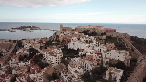 Aerial view of Eivissa Ibiza town with the port on the island of Ibiza with walls, towers, cathedral and blue sky
