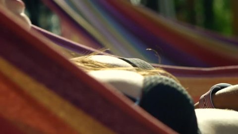 Girl with Attractive Big Breasts Smiling and Swinging on Hammock; Hot Female with Big Boobs Swinging on Hammock