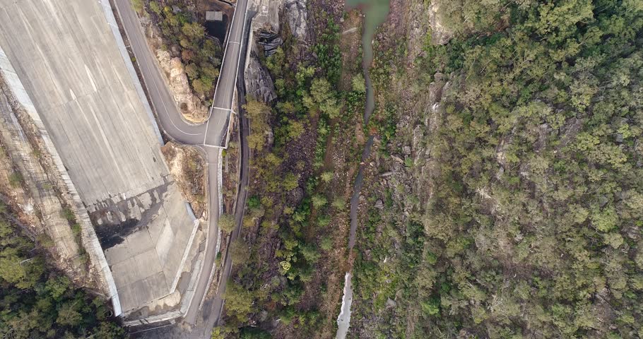 Massive concrete spillway for overflowing flood waters – part of Warragamba dam shuttering stream of Warragamba river in Greater Sydney area.
