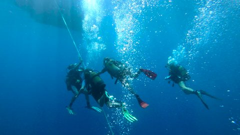 KAS, TURKEY - SEP 19: Group of scuba divers ascending on anchor line on September 19, 2018 in Kas, Turkey