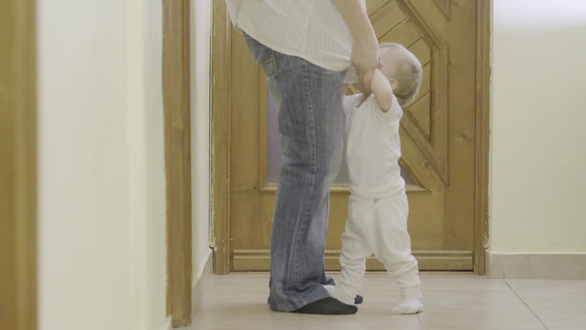 Spoiled baby pull on mother feet