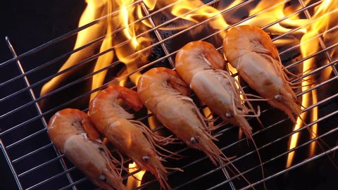grill shrimp , barbecue sea food on fire flaming slow motion background.