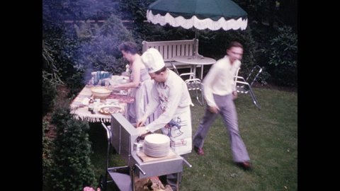 1940s: Man in chef's apron and hat tends to barbecue; guests socialize in lawn chairs.