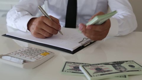 Man Settling Accounts Tax Calculation and Counting Money

