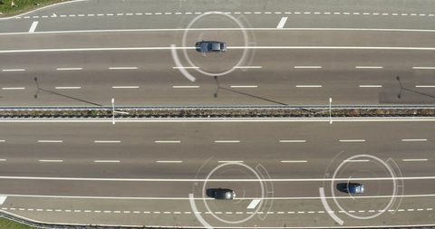 Aerial view of a highway where cars pass to go to the city and a futuristic graphic appears. Concept of: speed control, espionage, satellite control, connection.