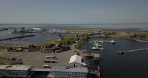 4K aerial sunny day video of harbour, fortifications, armaments, yacht club service area, Finnish Bay panorama, boats moored at Baltic Sea, in surroundings of Russia's northern capital