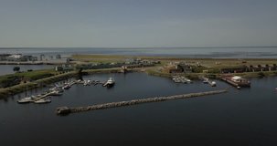 4K aerial sunny day video of harbour, fortifications, armaments, yacht club service area, Finnish Bay panorama, boats moored at Baltic Sea, in surroundings of Russia's northern capital