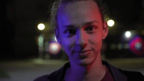 blue and red light on young men's face outdoors at night 4