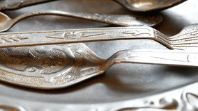lot of silverware with vintage jug on retro silver tray. vertical panorama close up shot