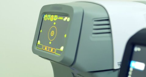 Modern automated machines examining eyeball. Professional medical equipment sliding close-up