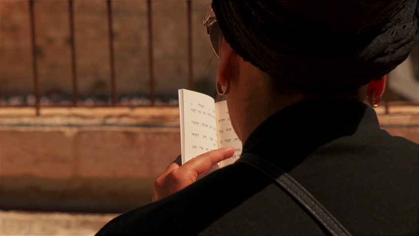 A religious jewish woman praying at the Western Wall, Jerusalem, Israel