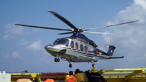 KELANTAN, MALAYSIA - September 1st 2018 : Helicopter landing on oil and gas platform helideck, transferring crews who worked in offshore oil and gas industry, air transportation for support passengers