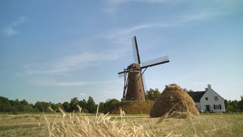 Romantic scenery of aTypical Dutch Windmill with a traditional hay bale - Slider / Wide Shot -
