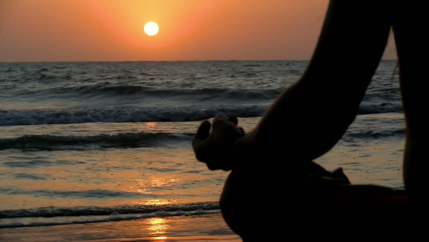 Young man practicing relaxation exercises by the sea. Golden sunset over the sea practicing yoga. Sunset on the beach meditating in front of the sun.
 Royalty-Free Stock Footage #1017352366