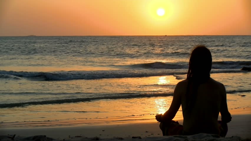 Young man practicing relaxation exercises by the sea. Golden sunset over the sea practicing yoga. Sunset on the beach meditating in front of the sun.
 Royalty-Free Stock Footage #1017352369